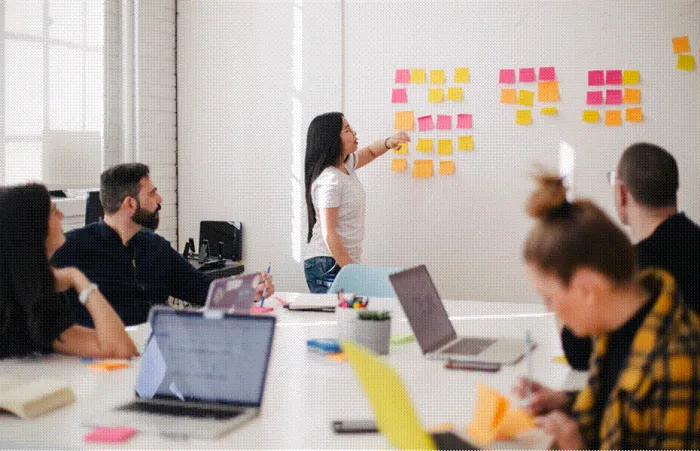 Title: Content team planning an article with colored sticky notes on an office wall - Description: Content team planning an article with colored sticky notes on an office wall